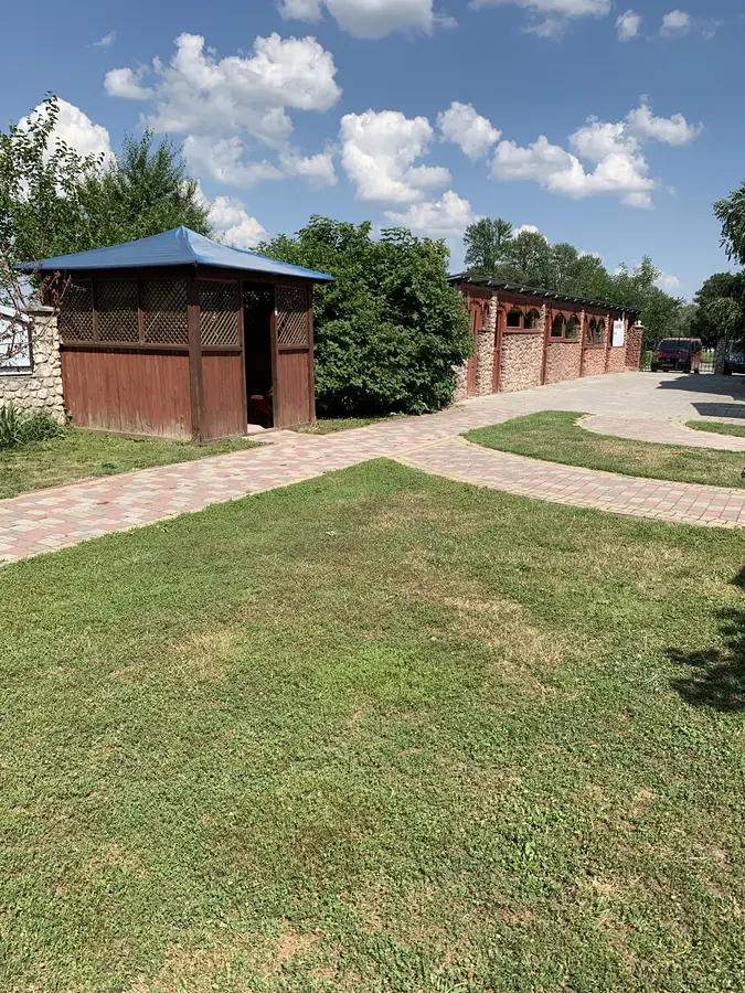 Зелений газон, доріжка та бесідки на території бару